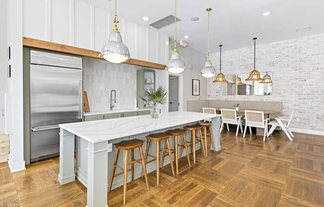 A kitchen with a white countertop and wooden floors.