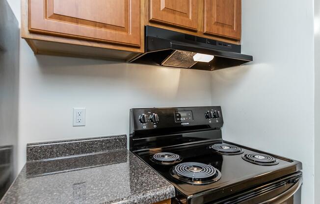 a stove top oven sitting inside of a kitchen