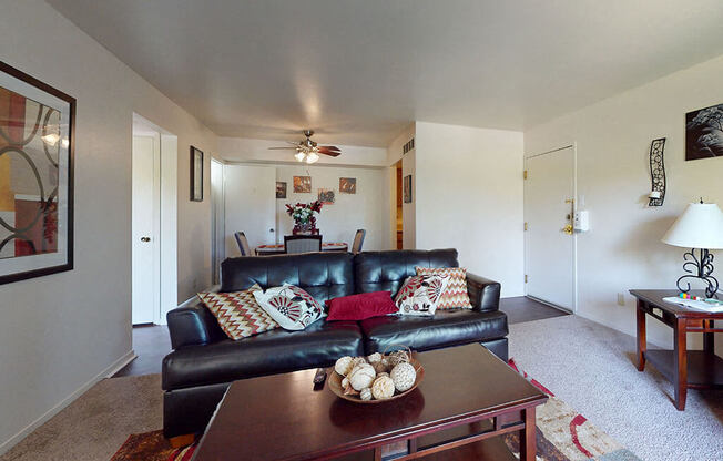 a living room with a leather couch and a coffee table