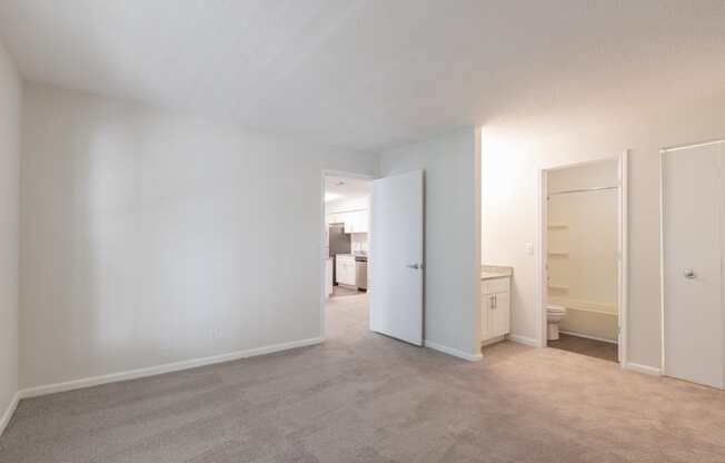 a bedroom with white walls and carpet