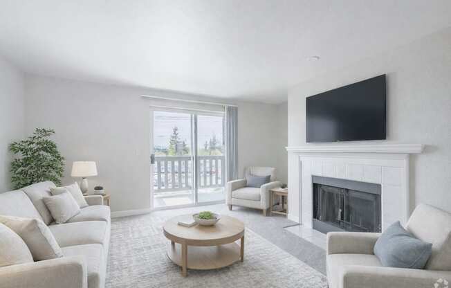 A living room with a fireplace and a flat screen TV mounted on the wall.