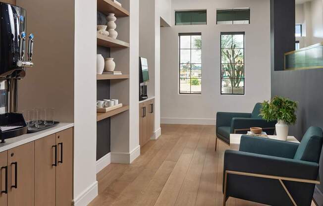 A modern kitchen with wooden floors and a large window.