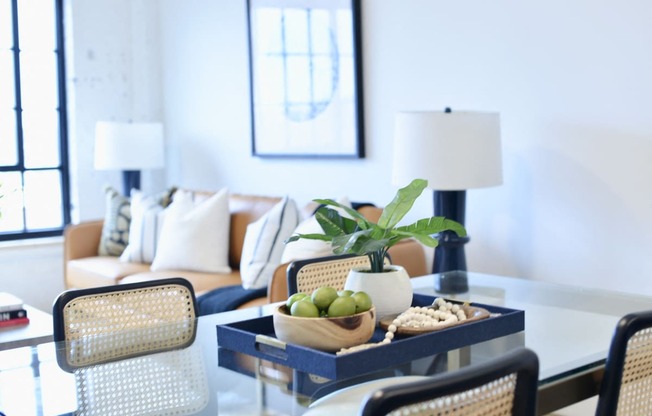 a living room with a table with a bowl of fruit on it