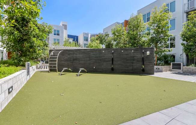 a backyard with a green lawn and a wooden fence