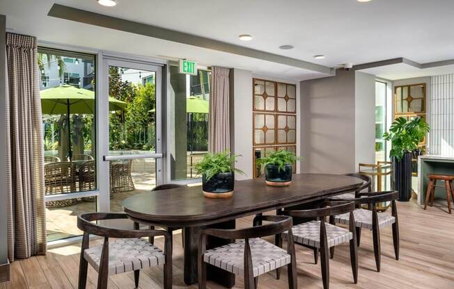 a dining room with a wooden table and chairs