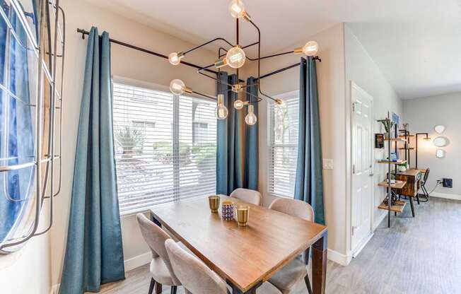 A dining room with a wooden table and chairs.