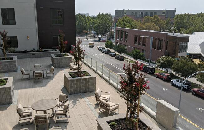 Rooftop terrace with seating, planters, and open views offering a comfortable spot to enjoy the neighborhood.