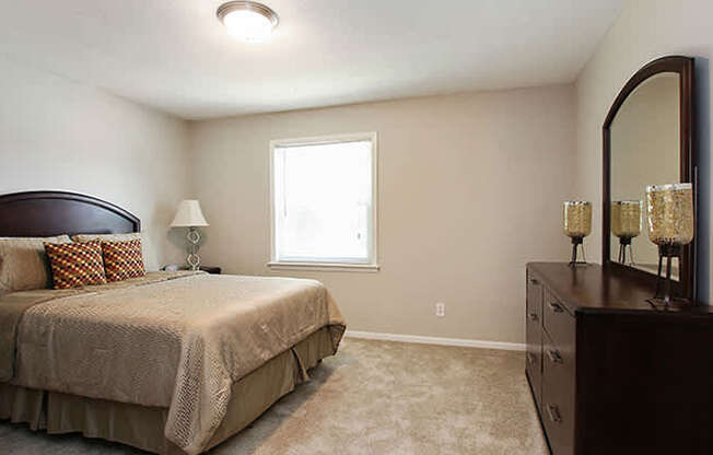 Pet-Friendly Apartments in Atlanta, GA – Estuary –a bedroom with a bed and a dresser