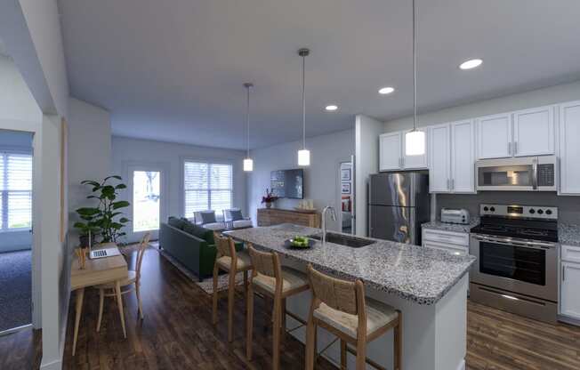a kitchen and living room with white cabinets and a granite countertop at The Bella at Westchester, Midlothian, VA 23113