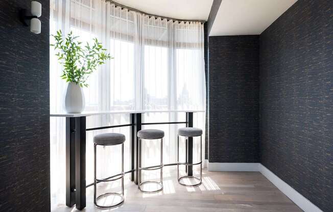a row of stools in front of a window in a room