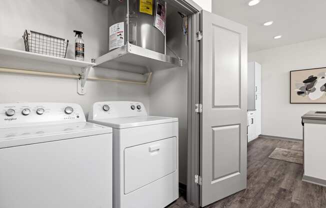 a white washer and dryer in a room with a refrigerator and a door at The Depot in The Depot Raymore, MO 64083