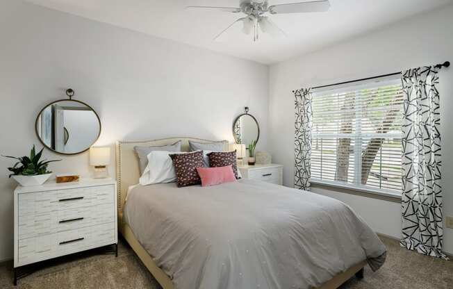 Model bedroom with ceiling fan at  Sandstone Creek Apartments Overland Park KS