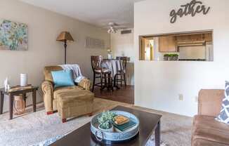 Foothills living room with carpet flooring and cozy couches and chairs