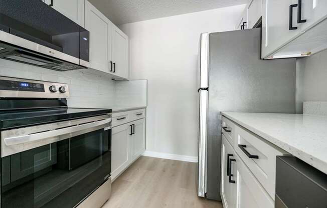 A kitchen with a stove, oven, and refrigerator.