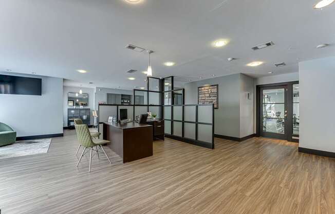 A modern office space with a wooden floor and a green chair.