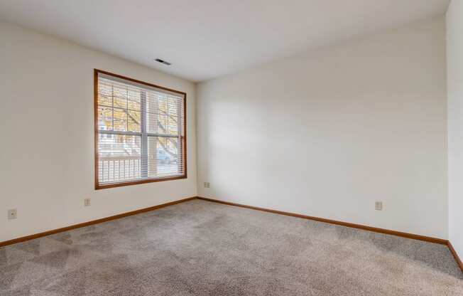 a living room with carpet and a window