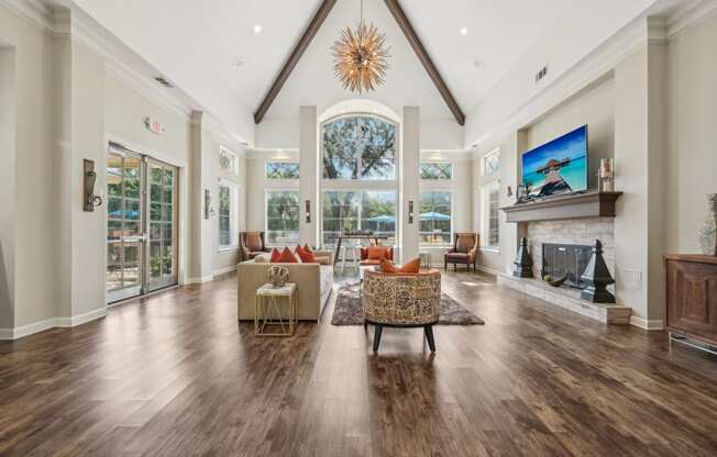 a large living room with a fireplace and a large window