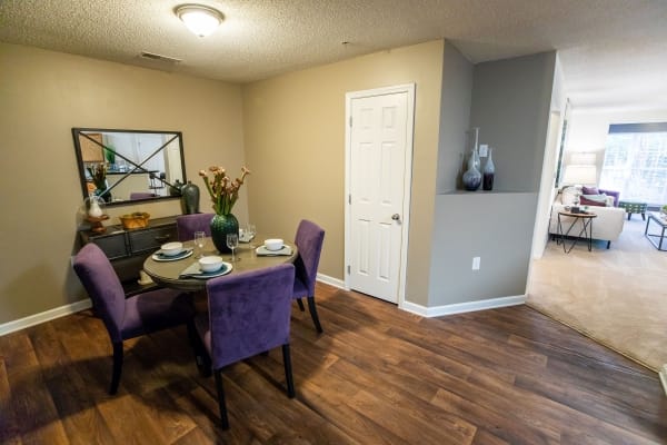 A dining room with a purple table and chairs.
