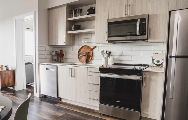 The kitchen features sleek stainless steel appliances.