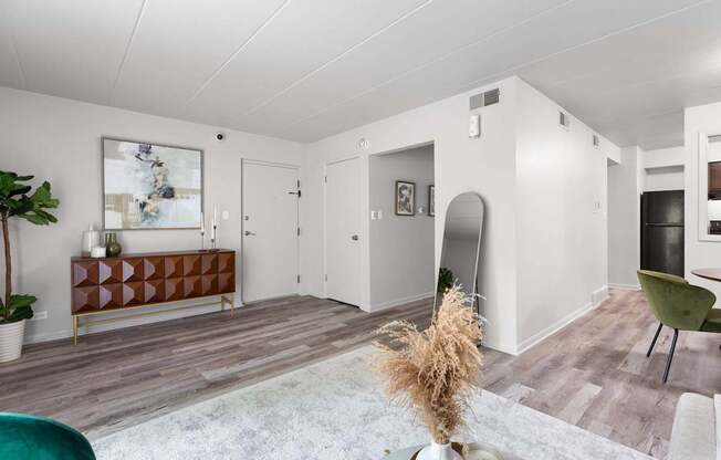 a living room with white walls and wooden floors