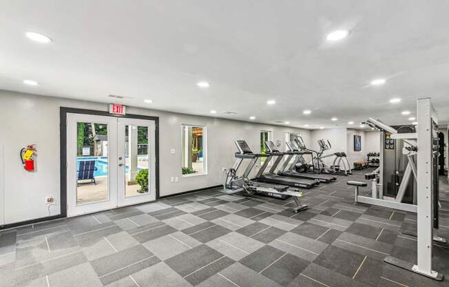 A gym with treadmills, weights and exercise machines.