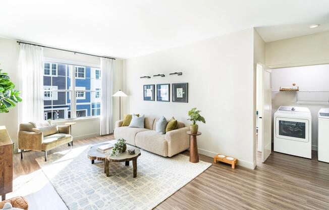 Natural light pours into this serene living space, complete with in-home laundry and warm coastal textures at Modera South Shore.