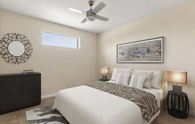 A bedroom with a large bed, a ceiling fan, and a decorative wall art.
