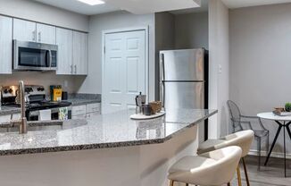 Renovated kitchen with stainless steel appliances and granite countertops at Elme Alexandria, Virginia