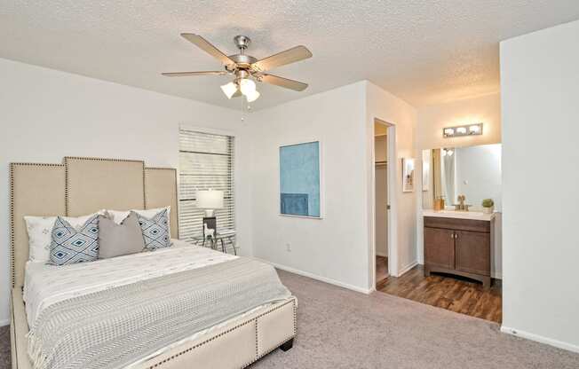 a bedroom with a bed and a ceiling fan