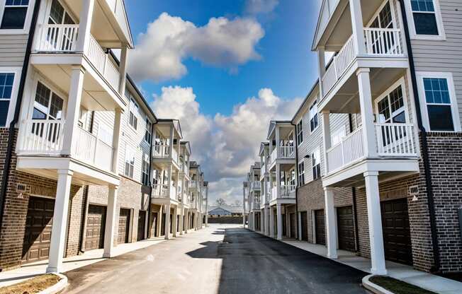 a street with rows of apartment buildings on each side