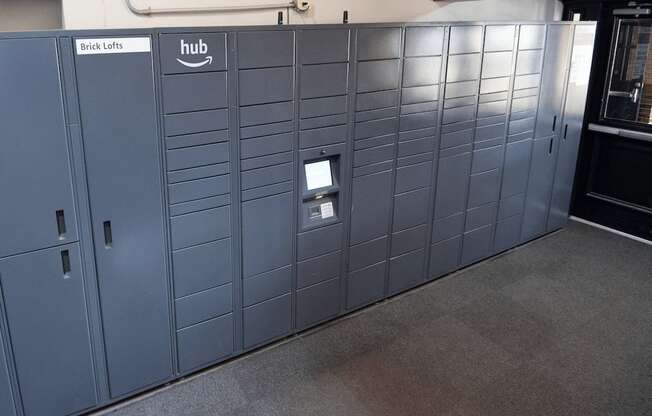 A row of lockers with a sign that says "Brick Lofts" and "hub".