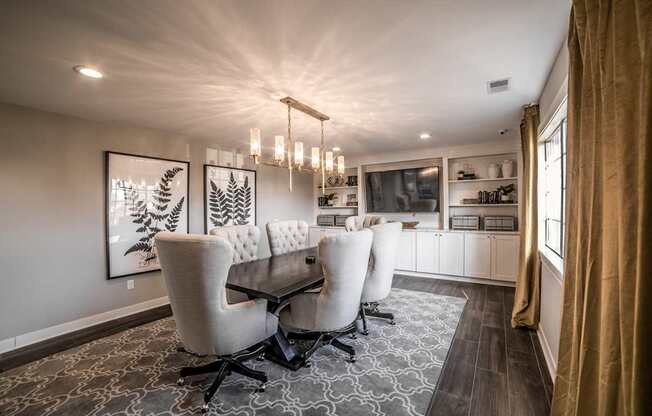 A dining room with a table and chairs.