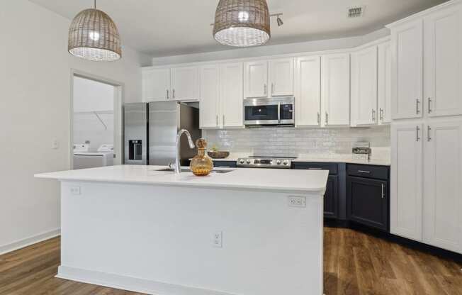 a kitchen with a large white island and black cabinets