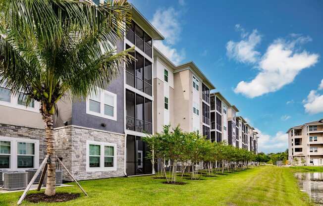 an apartment building with palm trees in front of it