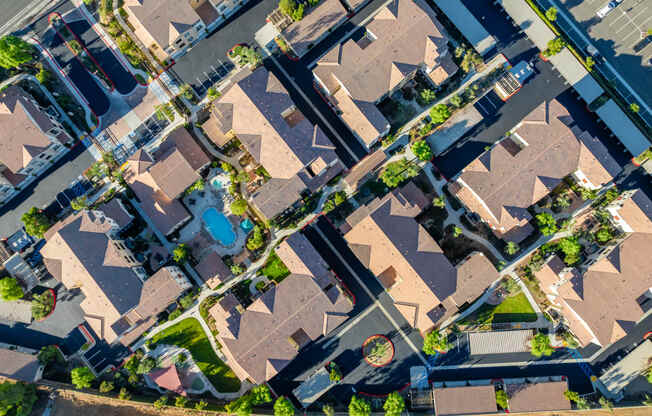 an aerial view of a suburban neighborhood with houses and cars