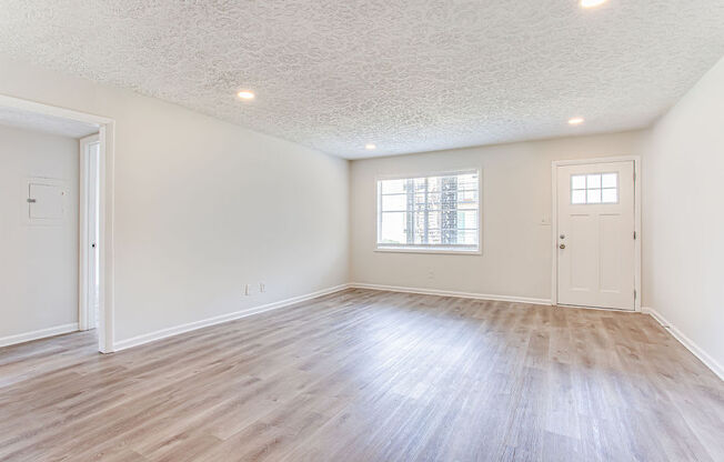 a bedroom with hardwood floors and white walls  at The Oasis on Cascade, Georgia