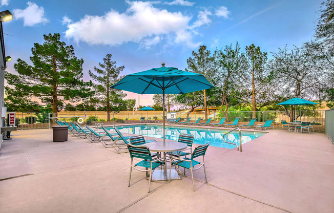 A poolside area with chairs and umbrellas.