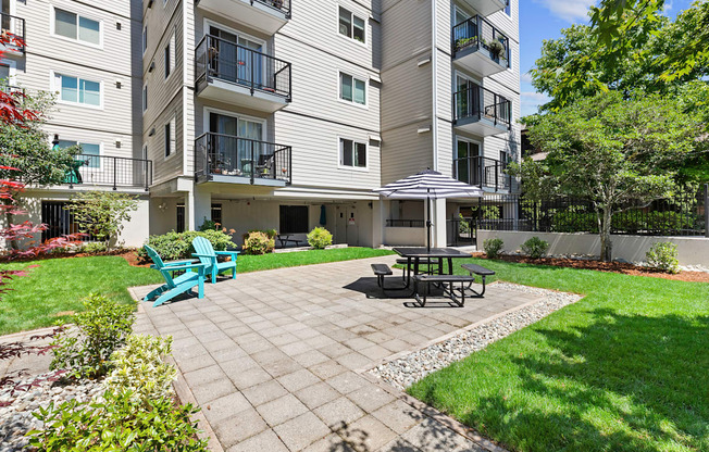 Resident patio space with a table and chairs for relaxing at King Arthurs Court, Seattle