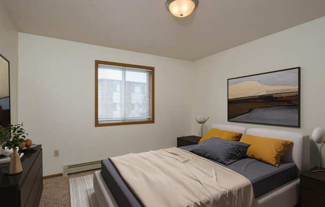 Fargo, ND Park Circle Apartments. a bedroom with a bed and a dresser