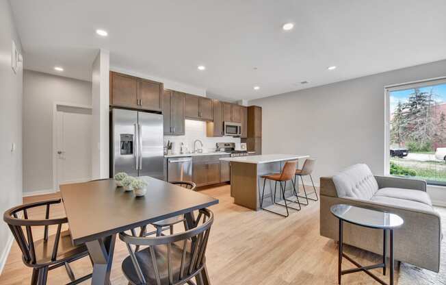 a kitchen and living room with wood flooring and a large window
