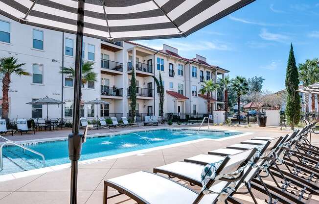 Swimming pool deck with chaise lounge   at Two Addison Place Apartments , Pooler, GA, 31322