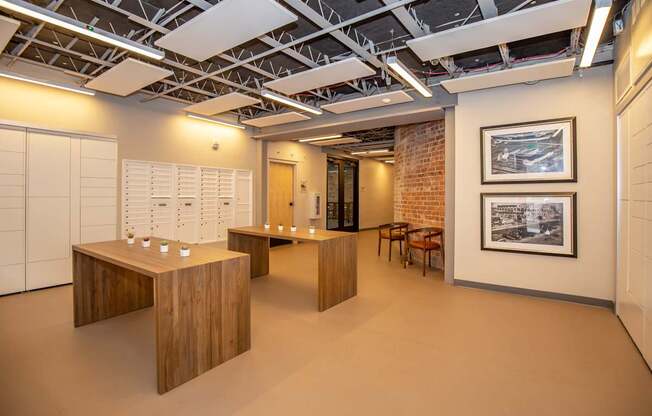 A room with a brick wall and wooden furniture.