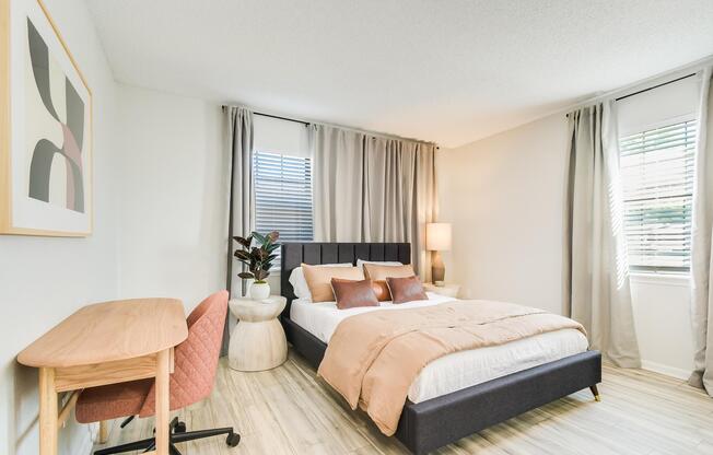 Bed and desk inside platinum bedroom interior at The Arbor in Blue Springs, Missouri