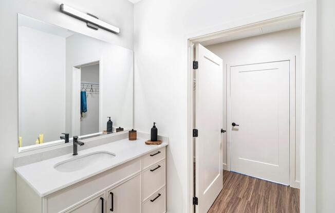 Bright finishes and clean lines bring a modern touch to this bathroom, complete with a spacious vanity offering generous storage below.