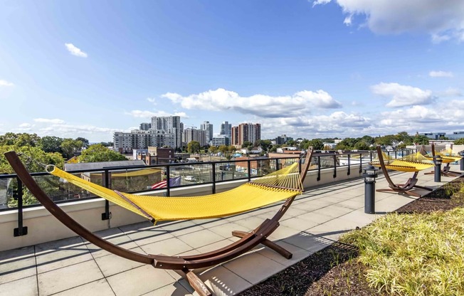 Rooftop outdoor space with hammocks and city views