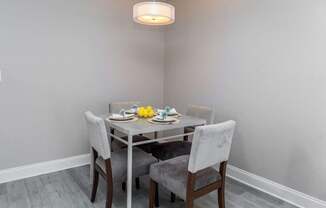 a dining room with a table and chairs