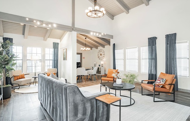 a living room with a couch and chairs and a table