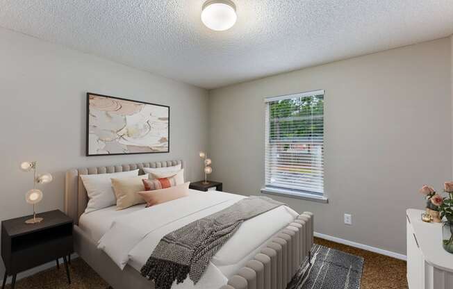 a bedroom with a large bed and two night stands with lamps on them