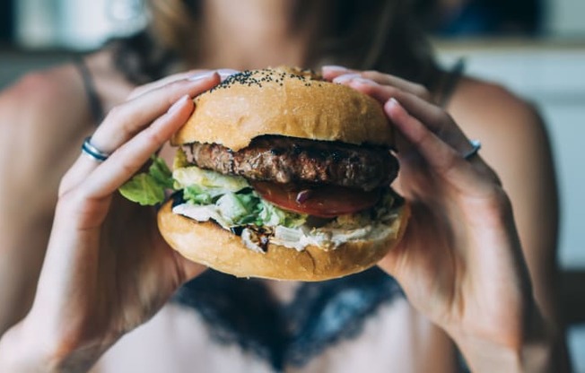 Woman Having A Burger at The Crest at Acworth, Georgia, 30102