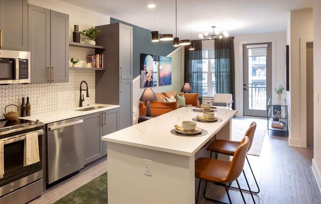 an open kitchen and living room with a table and chairs